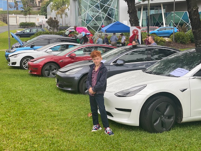 Line of cars - Jax Keating in front of Tesla Model 3